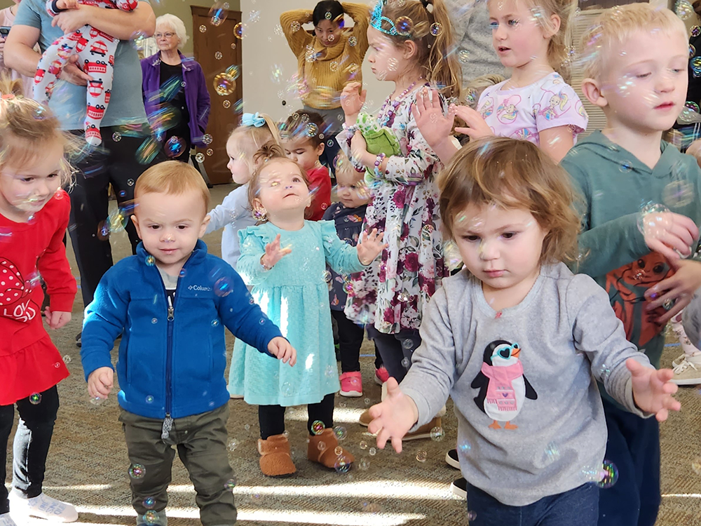 Bubble Boogie program showing a group of young children dancing with bubbles in the air