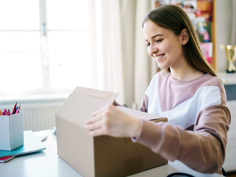 Girl opening a box and smiling