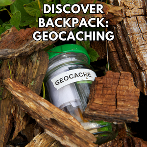 jar labeled geocache buried in tree bark