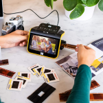 person pulling film strip from kodak converter
