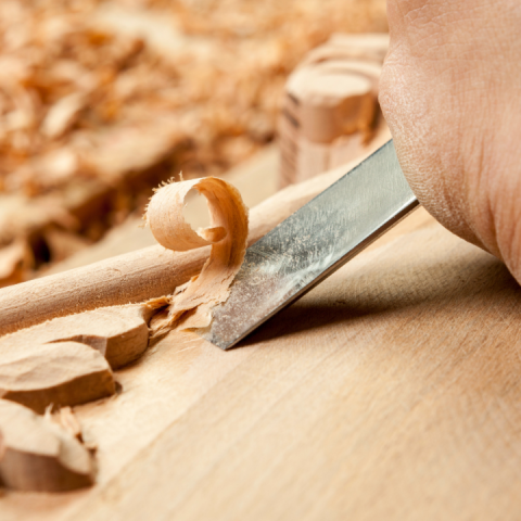 wood being carved with metal tool