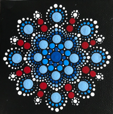 black canvas with painted dot mandala in blues and reds