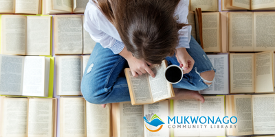 Image depicts a Young Adult Reading among a pile of open books. Mukwonago Community Library Watermark is applied. 
