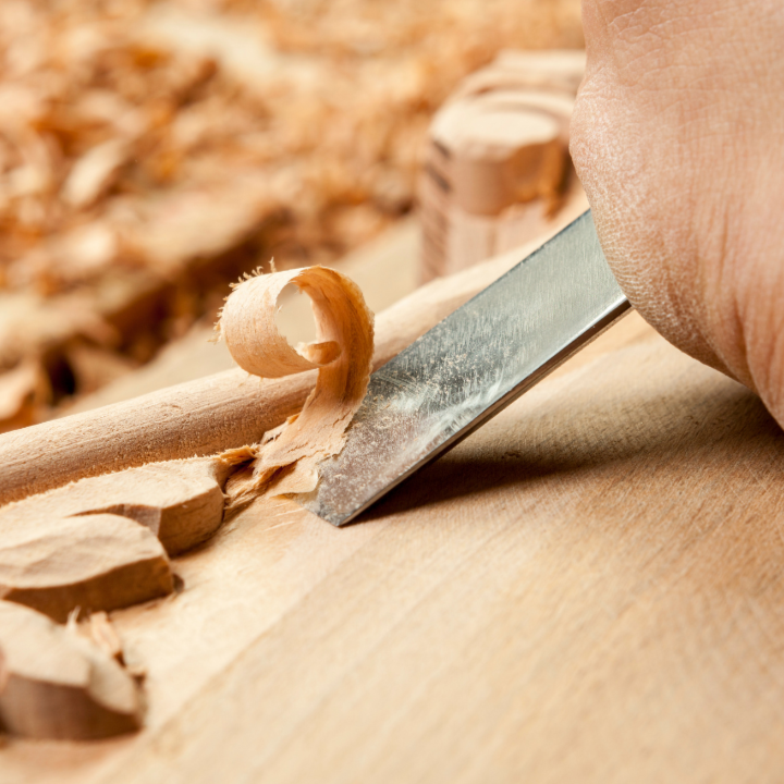 wood being carved with metal tool