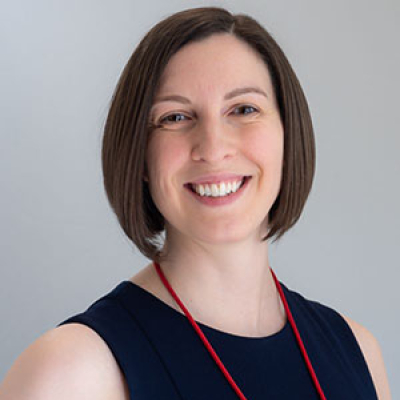Woman wearing a black sleeveless shirt with a red lanyard around her neck